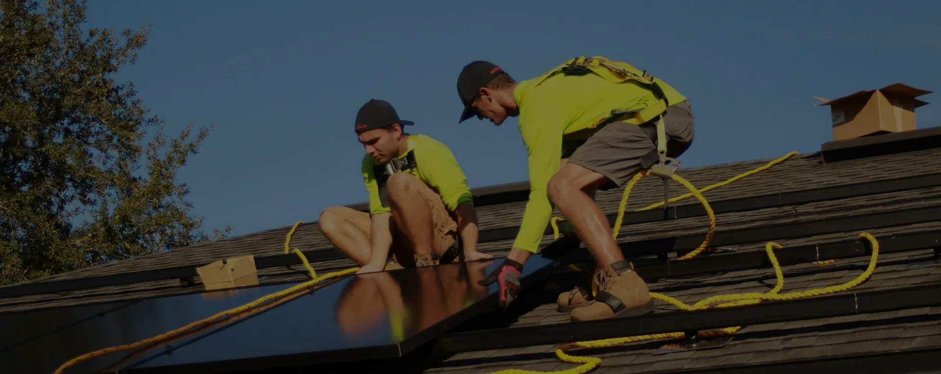 Solar installers working together on a rooftop