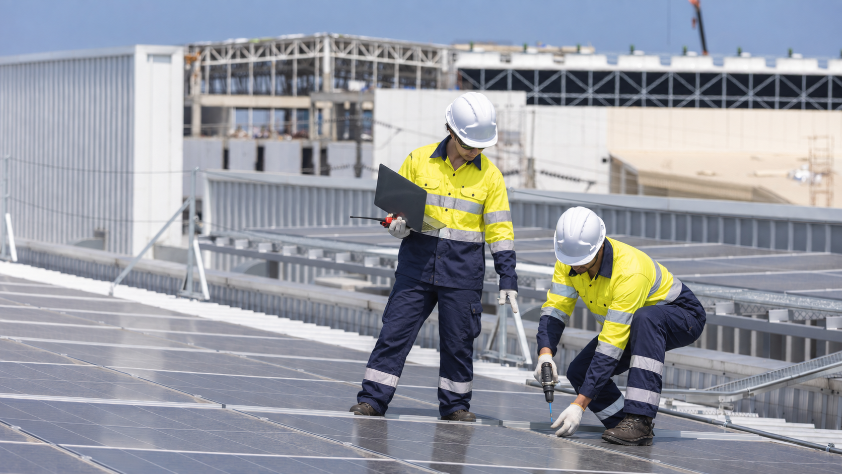 Solar technicians inspecting panels on a commercial rooftop