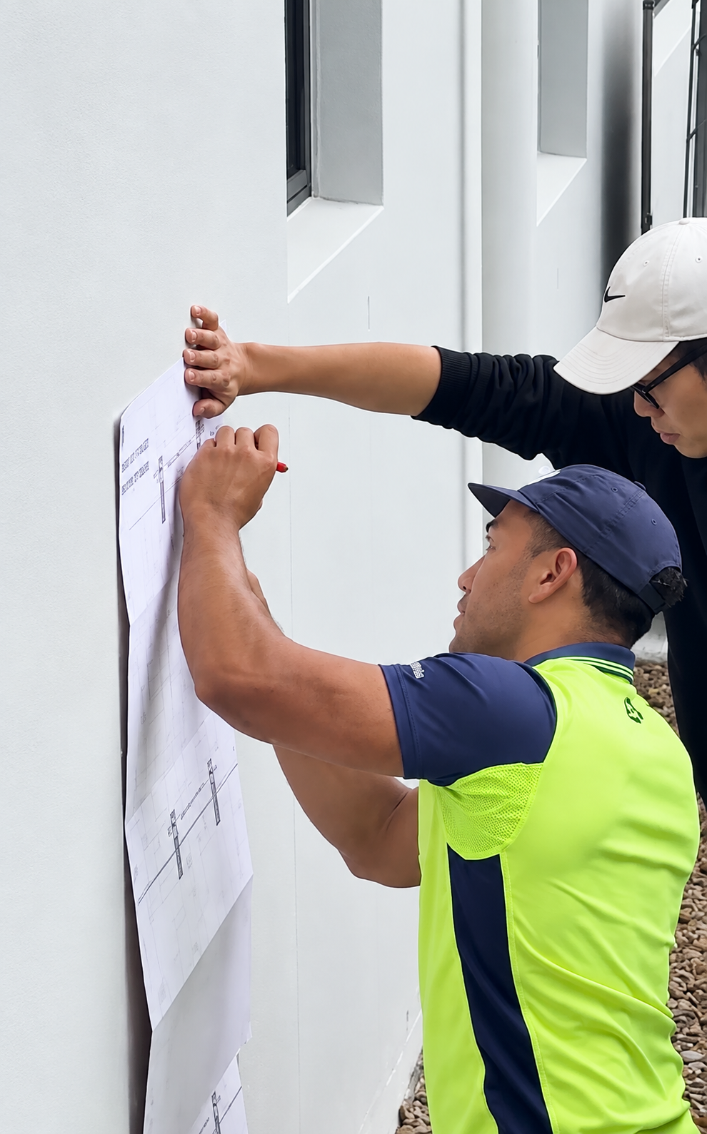 Sunbridge installation team reviewing plans at a home